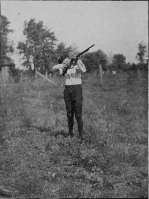 TEACHING A BOY TO SHOOT.