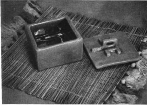 A ceramic box on a reed mat