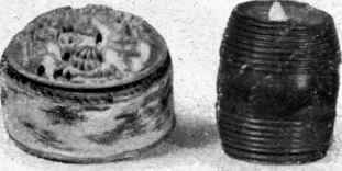 A round Pin cushion with Chinese carving on the top. The small barrel is a tape measure.