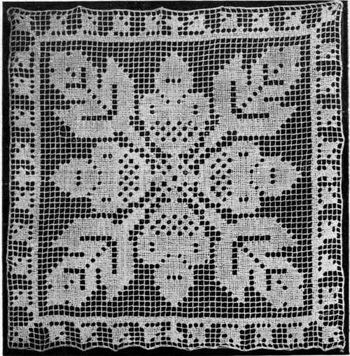 AN ACORN DESIGN IN DARNED FILET NET.