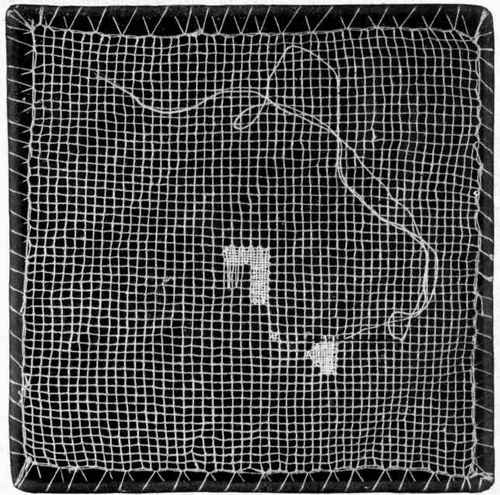 Net being darned in a frame.