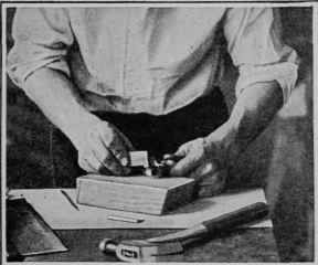 Doctoring the screw point with an oilstone (usually called a slip) that has a thin edge.