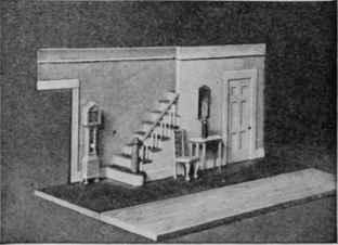 How the stairs are built and the hall is furnished with a miniature clock, table, chair, and mirror.