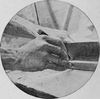 Laying out a measuring rod for a piece of furniture with the square held vertically.