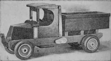 The dump truck has a foolproof elevating mechanism, the parts being a dowel, a spool, and a piece of tape dumping. A very good truck of this kind may also be built on one of the simpler chassis previously described.