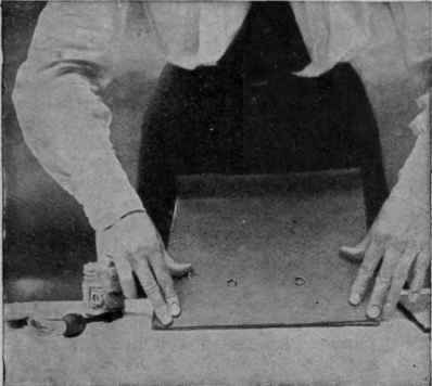 Pasting down a browrn paper backpiece, to make the frame neat at the back