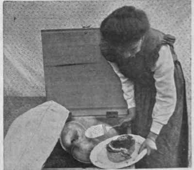 Removing a joint of meat from the cooker. Meat cooked in this way loses neither flavour nor nourishment