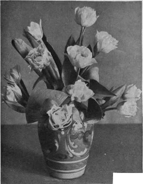 A beautiful effect of colour is produced by filling a deep blue vase with the palest of blush pink tulips