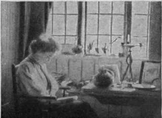 A cottage window. The curtains may be of scarlet twill or in casement cloth of an art shade