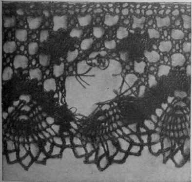 A ear in black lace which will be best mended by darning. The pattern is not definite enough to require tracing on a background