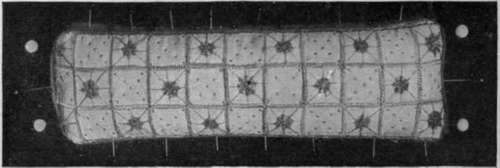 Closely woven glass cloth should be chosen For a pincushion. Close green silk buttonhole stitching covers each line and washing