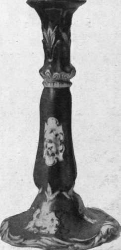 Rockingham candlestick, painted in coloured flowers on a claret ground and ornamented with gilding imitation of the Rose du Barri of Sevre