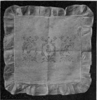 Table centre or cushion cover of frilled muslin with Coronation design painted in colour. The centre pattern only has the shield.