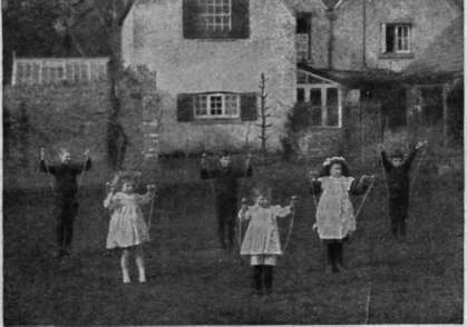The children in position ready to begin a skipping dance or game