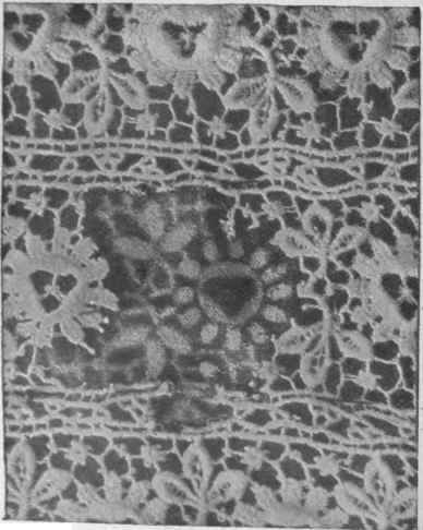 The first necessary step towards a repair of this nature is to get a whitened piece of the design on a green linen background and tack the lace exactly over it
