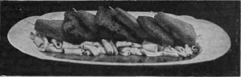 Veal and Ham Cutlets a la Romaine neatly down the middle of a hot dish, placing a cooked mushroom between each cutlet