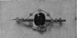 A green sapphire and pearls. These stones are very effective, and have almost the appearance of emeralds