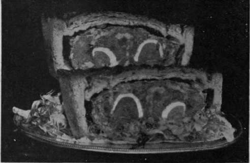 Veal and egg pies are easily packed, and are much liked at a picnic. They may be cut in half as here shown for convenience in serving