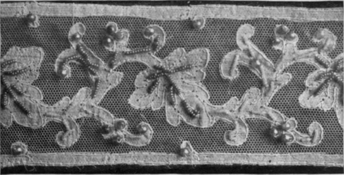 A conventional vine leaf design embellished with small pearls and turquoise blue Tuscan beads is a delightful trimming for a blouse