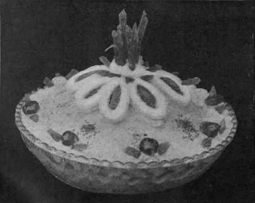 Banana Trifle. Decorated with angelica and pistachio nuts and pieces of red'currant jelly, a pretty scheme of colour is at once suggested