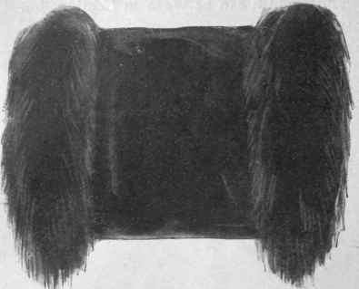 The front view of a pretty muff of velvet and fur, made from the ends of a fur stole of smoked fox. The velvet is grey and the lining is old gold brocade