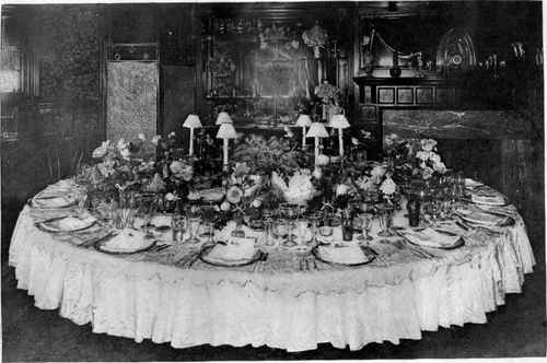 Round Dinner Table With Eighteen Covers.