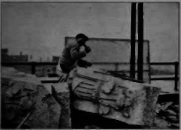 Using a Cloth Screen to Prevent chips of Stone from Flying into the Street.