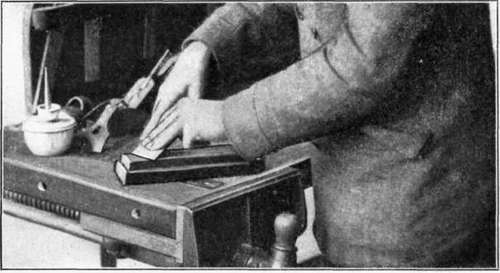 Fig. 27. Whetting, or Oilstoning, the Beveled Side of a Cutter.