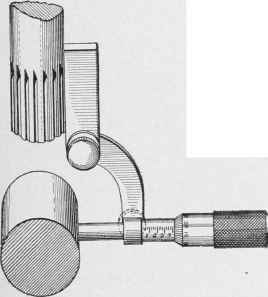 The micrometer attachment used for centering work under an end mill